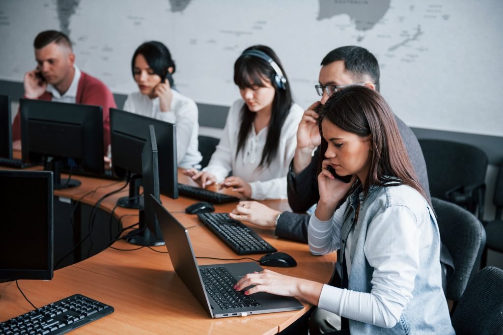 Noisy room. Young people working in the call center. New deals is coming